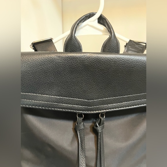 botkier trigger leather backpack NWT New York Details 100% polyester with 100% polyurethane trim Gunmetal hardware Magnetic snap flap closure Adjustable nylon webbed backpack straps Interior zip pocket Lining 100% polyester Measurements Height 9 in (23 cm)Length 9.5 in (24 cm)Depth 4 in (10 cm)Strap Length 33 in (84 cm)Strap Width 1.5 in (4 cm) Botkier Black Backpack New York